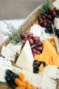 platter with assortment of cheeses and grapes