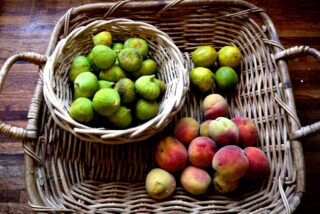 Peaches, figs and limes in a square basket