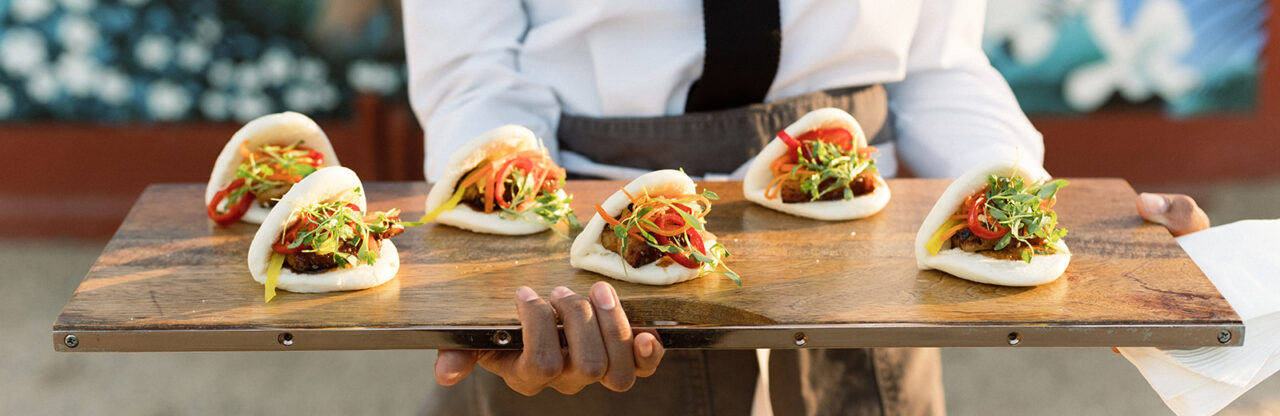 Staff holding a taco board