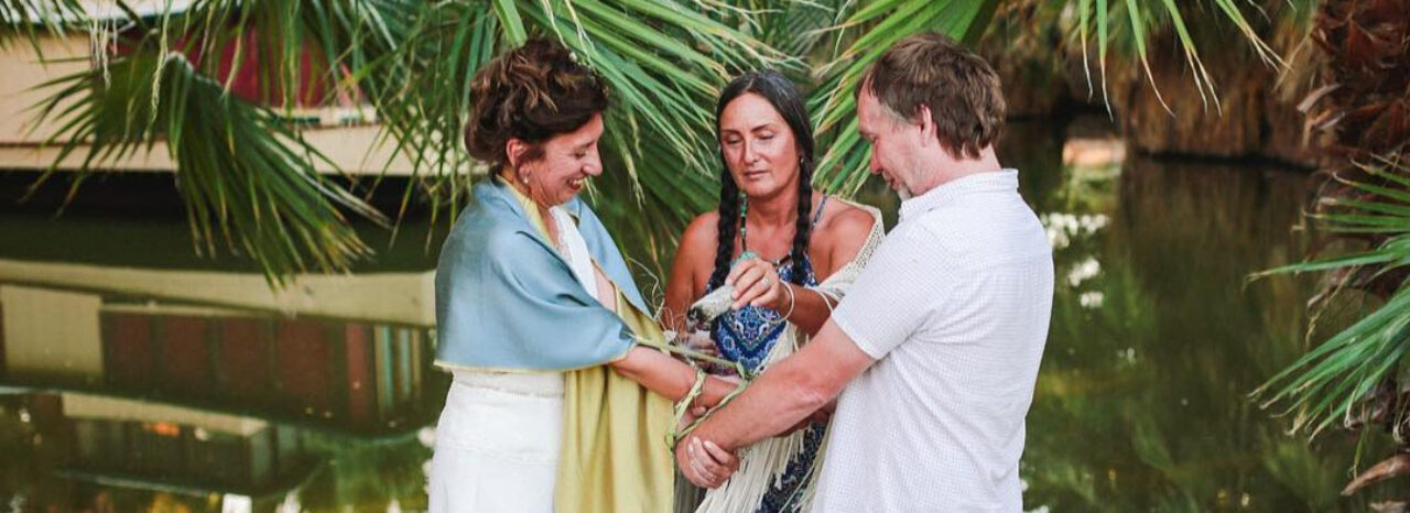 A wedding ceremony taking place on the edge of the oasis